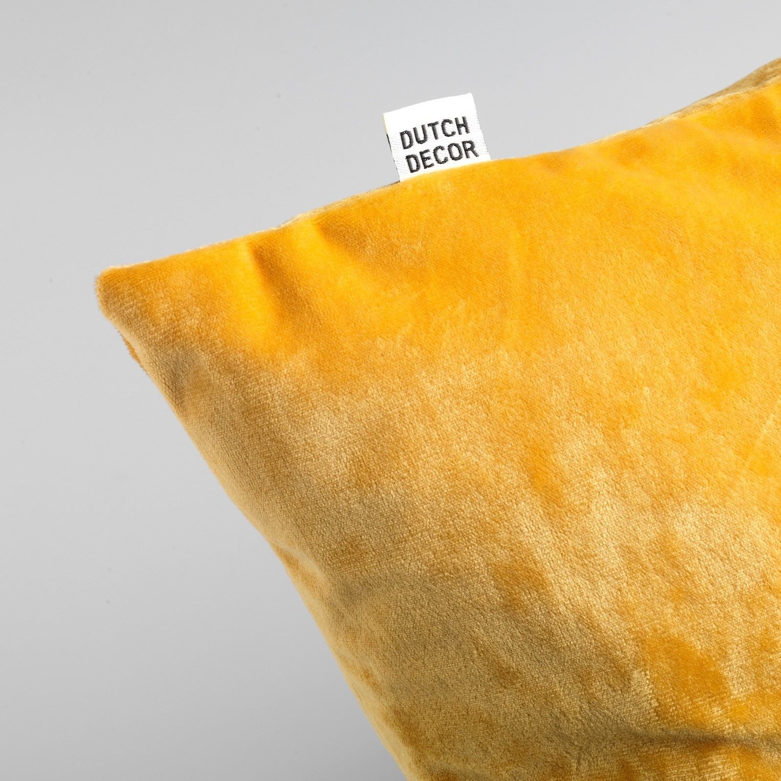Sierkussenhoes van goudgele fluweelachtige stof met klein Dutch Decor label