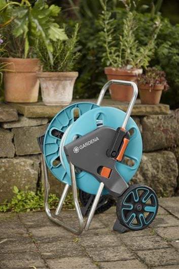 Gardena slangenwagen met haspel op stenen terras, turkoois/grijs met oranje accenten