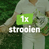 Mestzak voor gazon met groene opdruk '1x strooien', vastgehouden