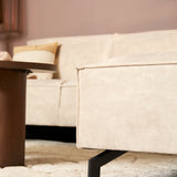 Beige fluwelen armleuning met siernaad en zwarte poot