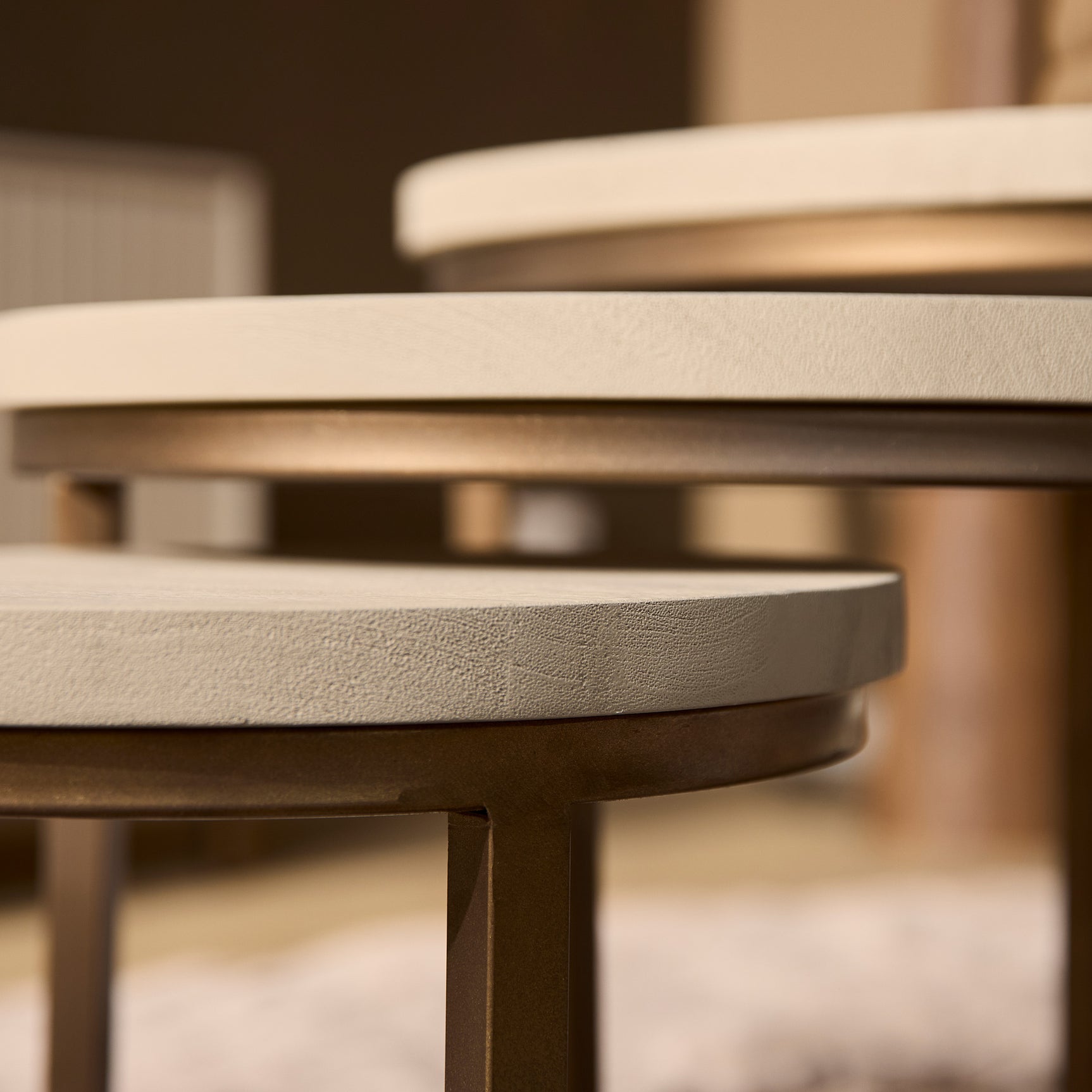 Salontafel met zandkleurig rond blad en donkerbruine rand en poot