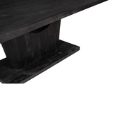Zwarte eettafel, close-up van bladrand en centrale poot met houtnerf en glans.