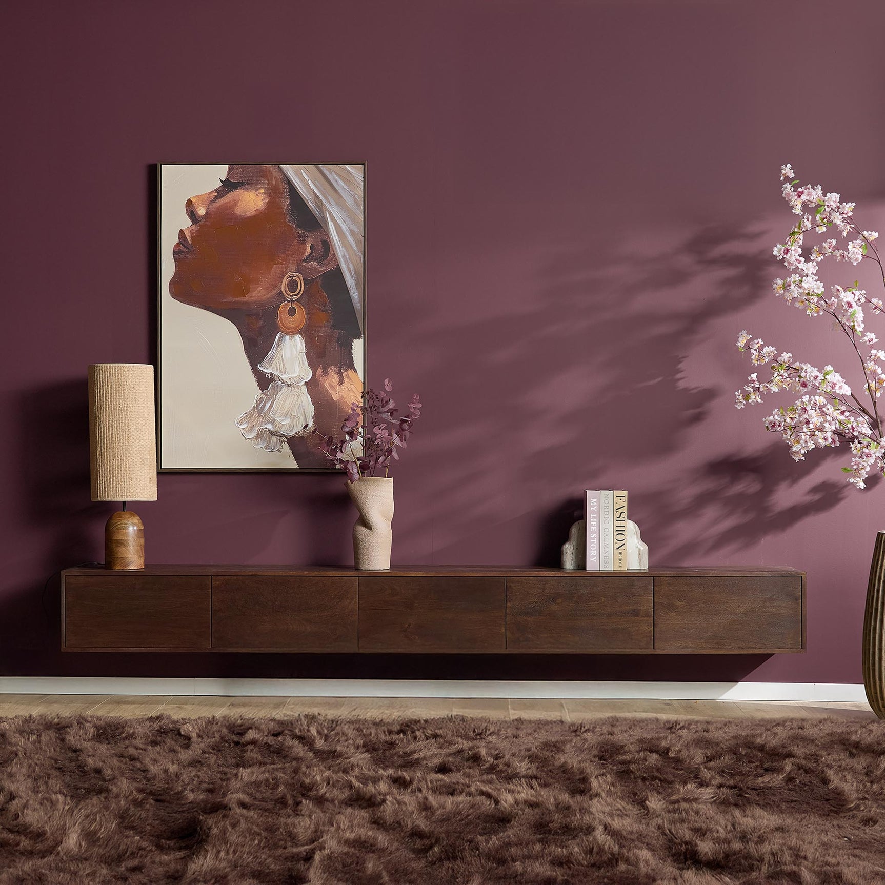 Zwevend tv-meubel bruin hout met ladefronten, met boeken en decoratie op blad
