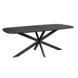 Ovale eettafel met donker houten blad en zwart kruisvormig onderstel.