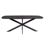 Ovale eettafel met rond donker blad en taps kruis onderstel in zwart.