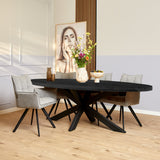 Ovale eettafel met zwart blad en centrale X-vormige poot, donker hout.