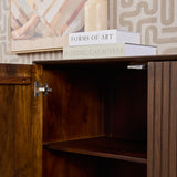 Bruin dressoir met open deur en schap, metalen scharnier en greep zichtbaar