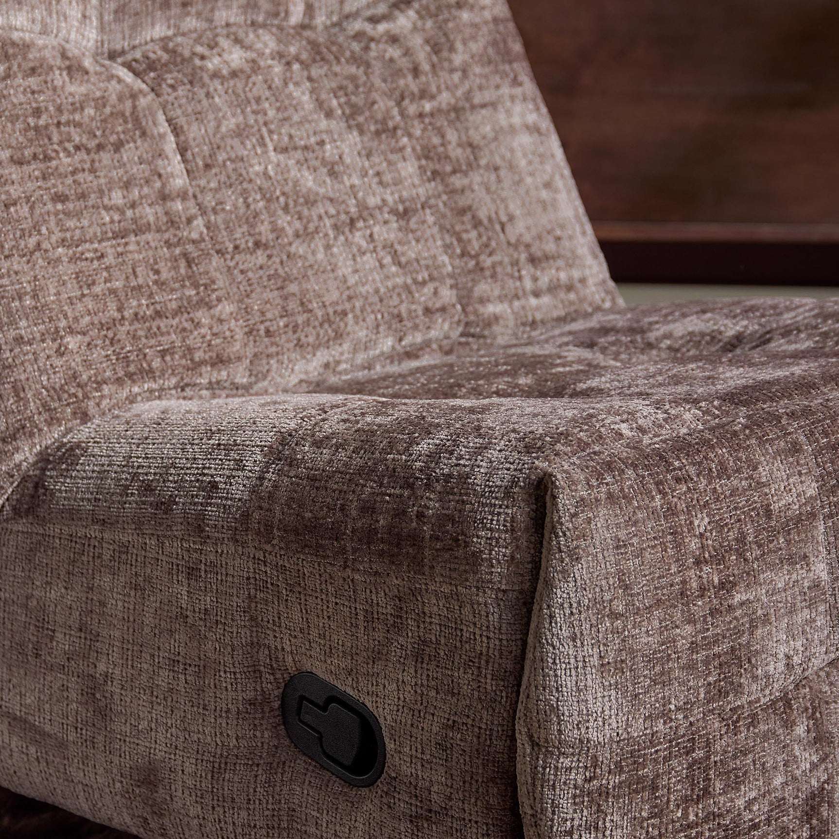 klei-kleurige relaxfauteuil met zwarte bedieningsknop op armleuning